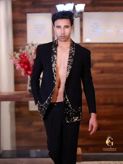 For the man who isn't afraid to make a statement. This black blazer with gold sequin lapels is a showstopper, perfect for a high-fashion event or a glamorous party.