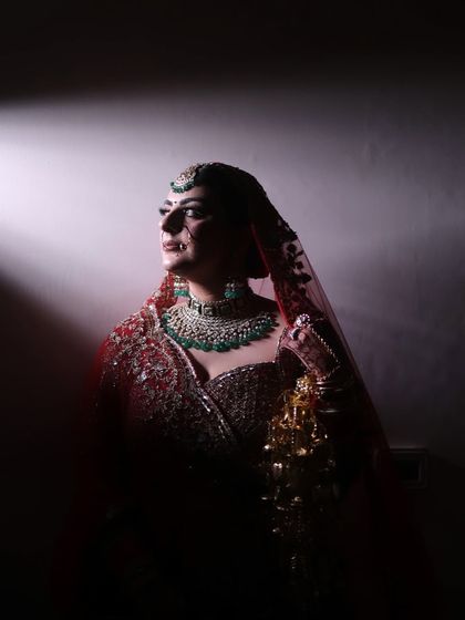 A dramatic, artistic shot of my bride Kaveri. The lighting highlights the sharp contour and the perfect winged liner, creating a powerful and memorable bridal portrait.