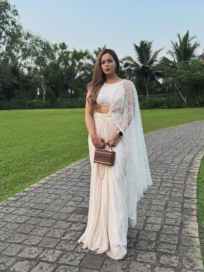 I have two personalities: one is serious and poised, the other is full of laughter. This elegant white saree brings out both.