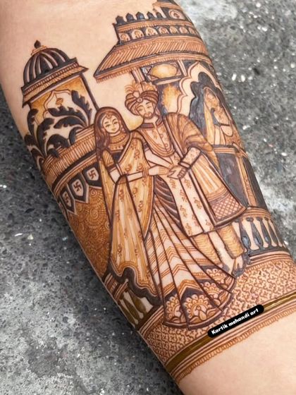 A close-up of a beautifully rendered couple portrait. The detail in their clothing and expressions showcases our expertise in creating lifelike figures for your bridal mehandi.