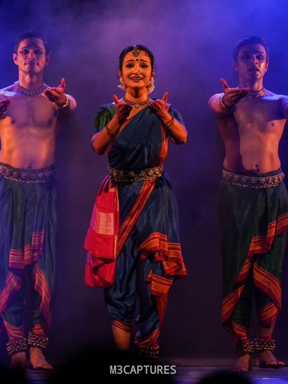 The cast of 'Nagamandala' in a powerful group pose. The use of smoke and colored lighting here helps to build a specific mood, transforming the stage into another world.