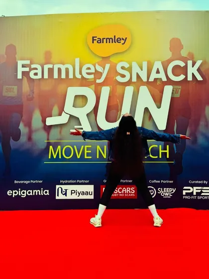 The joy of running. A participant poses against the backdrop of the Farmley Snack Run.