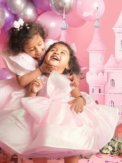 The sound of sisters giggling is pure magic. For this themed kids photoshoot, we created a fairytale castle where their imaginations could run wild, resulting in portraits filled with authentic laughter and playful energy.