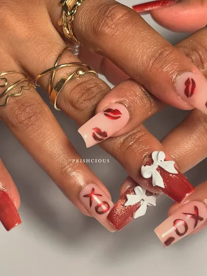 A close-up on the details of this Valentine's Day nail art. The combination of red glitter, nude base, and playful designs is perfect for the season of love.