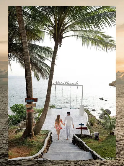 The couple walking towards the iconic Nui Beach swing set.