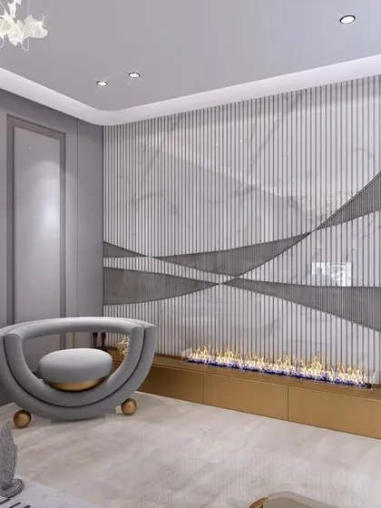 This unique seating arrangement includes a curved, sculptural armchair next to a modern fireplace feature. The wall has a dynamic, wavy texture, adding movement and interest to the room.