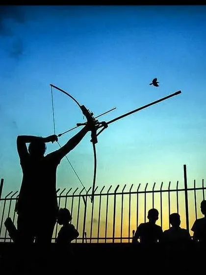 A silhouette of an archer at sunset. This captures the beauty and dedication that defines the life of an archer.