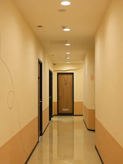 The clean and serene hallway leading to our private treatment rooms in Noida.