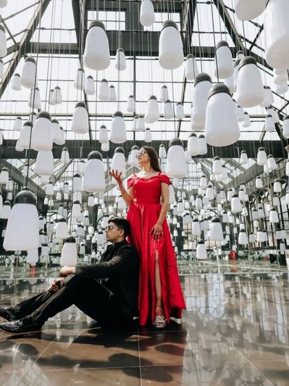 This red satin gown creates a striking image in this unique, artistic setting. The simple elegance of the dress allows the creative backdrop to shine.