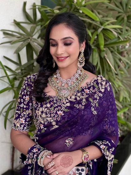 An elegant, eyes-closed shot to highlight the shimmering purple eyeshadow.