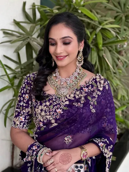 An elegant, eyes-closed shot to highlight the shimmering purple eyeshadow.