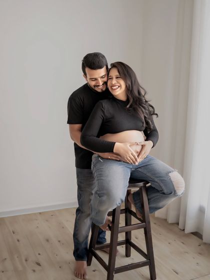 A sweet gesture, making a heart shape on the baby bump. This is a classic and adorable way to show love for the little one on the way in a relaxed, casual setting.