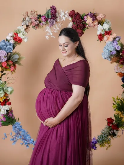 A moment of quiet reflection for the mother-to-be. Surrounded by a beautiful floral hoop, this portrait captures the serene and powerful glow of pregnancy in our Shimla studio.