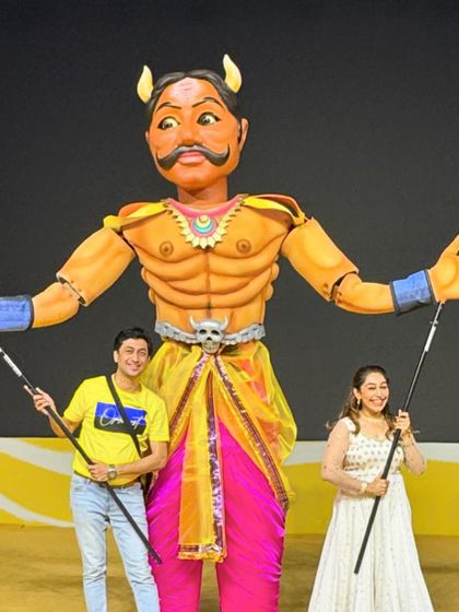 My wife Rujuta and I with one of the giant puppets. It's always a team effort, and having my family involved in these large-scale projects makes the work even more special.
