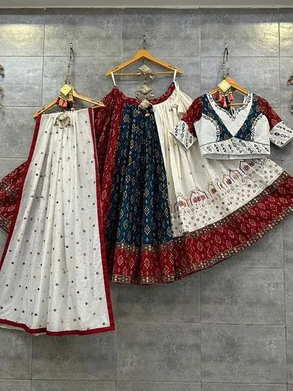 A gorgeous white and red chaniya choli with touches of blue. The printed skirt and embroidered blouse are a perfect combination of traditional and contemporary design.