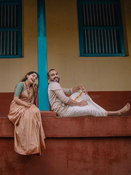 A fun and relaxed pose, with him lounging while she leans against the wall. This has a very natural and unstaged feel.