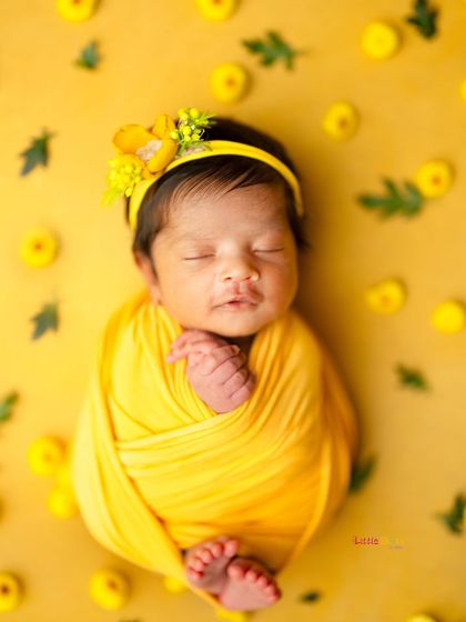 Sleeping soundly, this baby is a bundle of sunshine wrapped in yellow and surrounded by matching flowers.