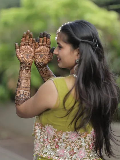 A side profile of the bride, showing off her palms. The intricate design is a work of art that she will cherish.