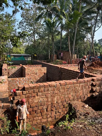 The foundations for Aadi Villa in Goa are laid with laterite stone, while stabilized earth blocks are prepared for the walls. This project is an exploration in building entirely without cement, using locally sourced and recycled materials.