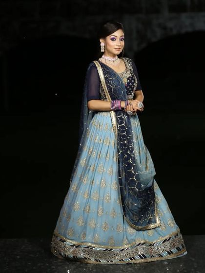 A serene and elegant light blue lehenga with gold work. This is a perfect choice for a daytime engagement or a summer wedding.