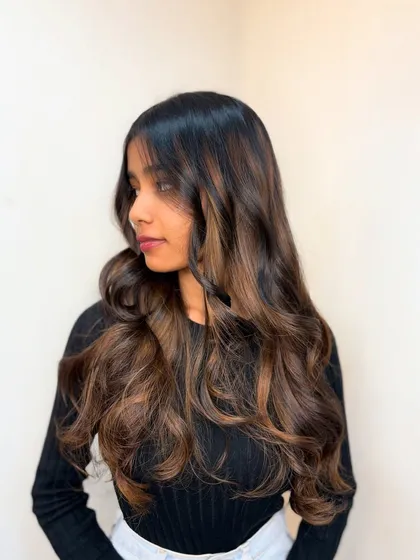 A beautiful example of our balayage work. The seamless blend of brown tones and expert styling creates a soft, natural-looking result.