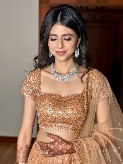 A close-up of the reception makeup. Softly smoked-out eyes and a neutral lip color create a sophisticated and modern glam look.