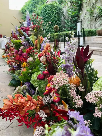 Adorning milestones with flowers is a very human thing to do. This long, low arrangement is a riot of spring color, designed to elevate the beauty of an everyday moment and encapsulate a time and place: Spring, in Gurgaon, India.