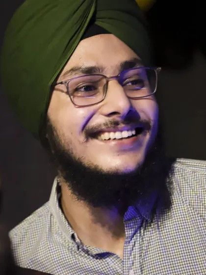 A candid portrait of a student enjoying the party. My style is to find these genuine smiles in the crowd to show the real atmosphere of the event.