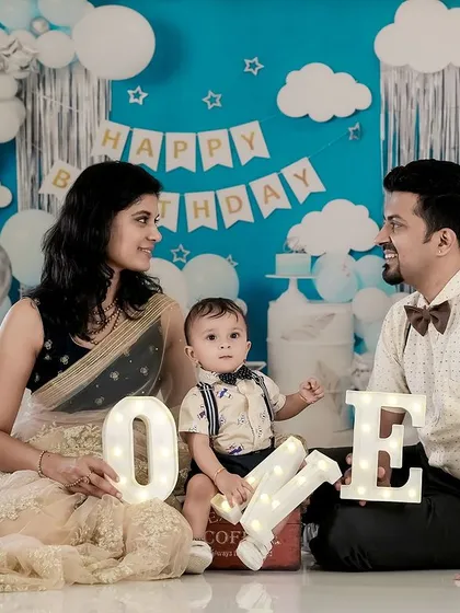 Happy First Birthday. We helped this family celebrate their son's big "ONE" with a custom birthday setup in our studio, complete with balloons and festive decorations for a memorable milestone photoshoot.