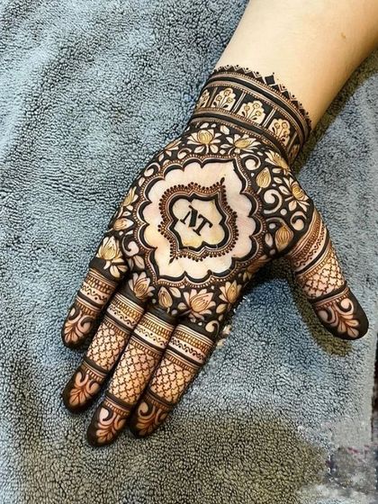 A personalized design featuring the couple's initials inside a decorative frame, surrounded by lotus and floral patterns.