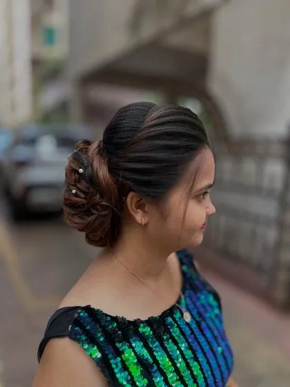 The hairstyle on a model, showing how it complements an evening look.