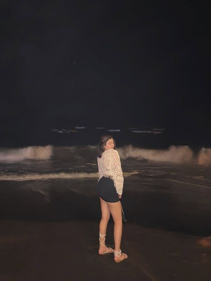 A happy, candid moment on the beach at night, with the waves crashing behind me.