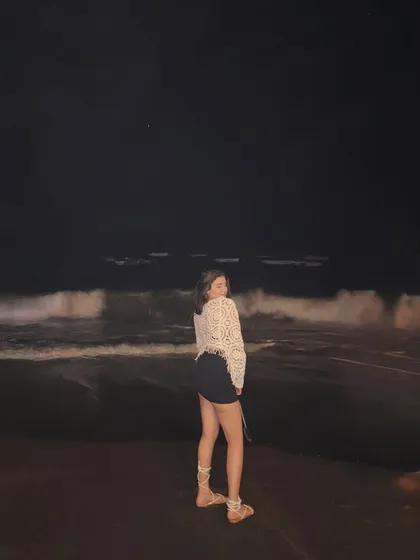 A happy, candid moment on the beach at night, with the waves crashing behind me.