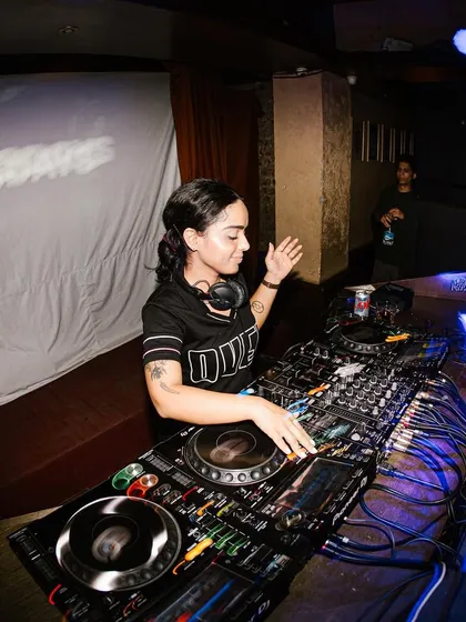 A happy moment at the decks. This shot captures the joy and energy I bring to my performances, ready to make you dance.