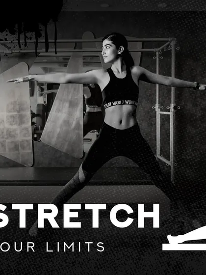 I am here to help you stretch your limits, both physically and mentally. This image captures the focus and determination we cultivate in our sessions, set against the backdrop of our professional studio.