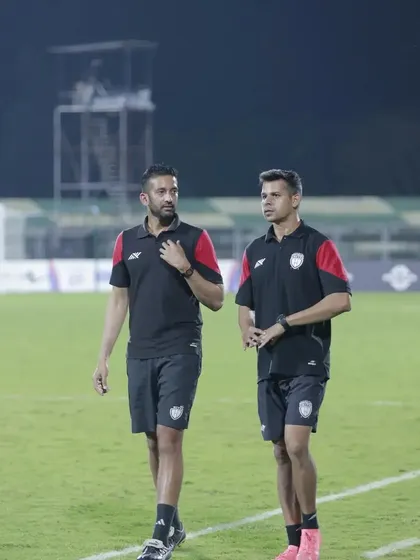 Walking the pitch with the head coach, discussing strategy and performance. Constant communication and alignment are crucial for success.