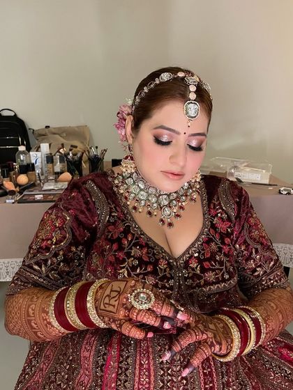 A soft peachy look for my beautiful bride Juhi. This seated portrait showcases her intricate henna and the flawless finish of her airbrush makeup.