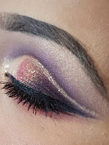 This is a double cut crease with a pop of pink and purple glitter. This intricate eye makeup is perfect for sangeet or reception nights when you want a bit of color and sparkle.