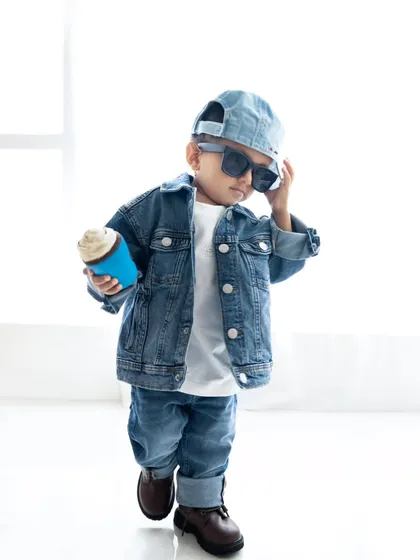 This little guy has so much style. A modern toddler portrait that captures his cool personality, featuring a denim-on-denim outfit and sunglasses.