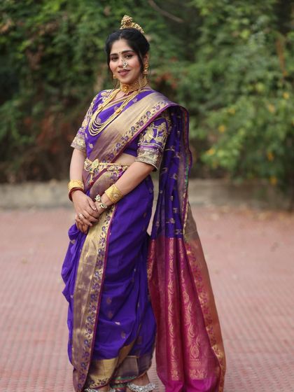 A full view of the stunning purple Paithani-style Nauvari. The intricate border and rich colour make it a truly special outfit.