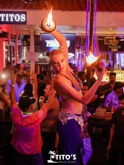 A skilled fire dancer performing for the crowd at Tito's. This kind of live entertainment adds a unique and thrilling dimension to any party.