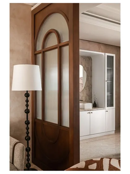 Another view of the elegant partition, showcasing its arched design and the warm tones of the wood. It acts as a beautiful architectural element in its own right.