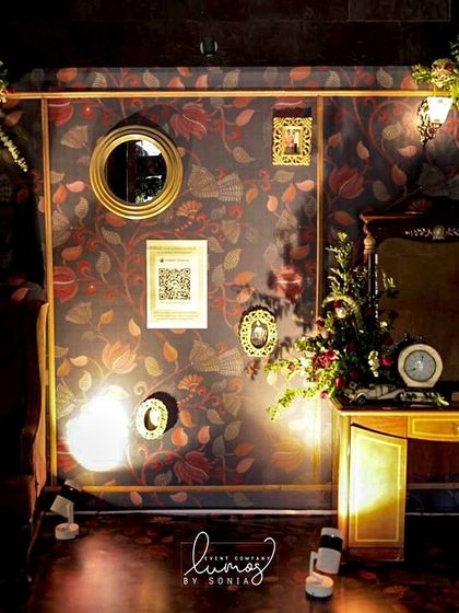 A special corner dedicated to the bride and groom's story, featuring a royal chair, a honeymoon fund QR code, and a vintage car model.