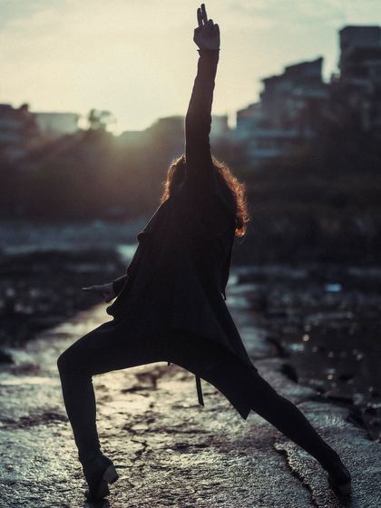 A powerful Flamenco pose silhouetted against the light, evoking a sense of drama and strength.