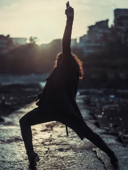 A powerful Flamenco pose silhouetted against the light, evoking a sense of drama and strength.