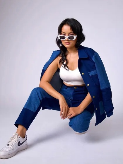 A full-length shot showing the complete streetwear look for Raki Designs, with simple makeup and hair.