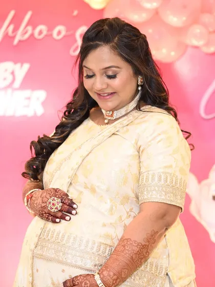 A sweet moment captured. The soft glam makeup is perfect for this happy occasion.