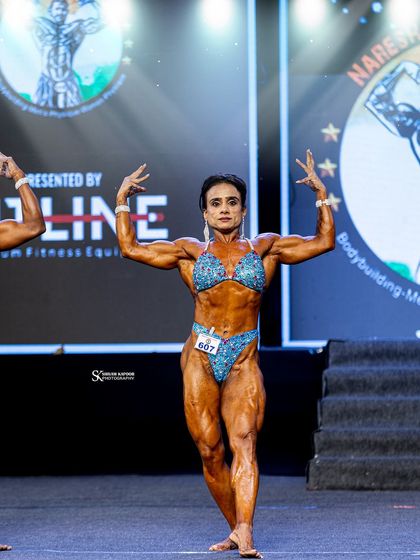 My athlete Anshul, commanding the stage at the Naresh Surya Classic. Her posing, conditioning, and presence are a testament to our detailed preparation.