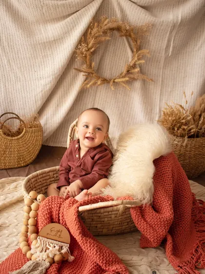 The pure joy of a sitter session. This baby boy's happy laugh is infectious in this warm, rustic setup.