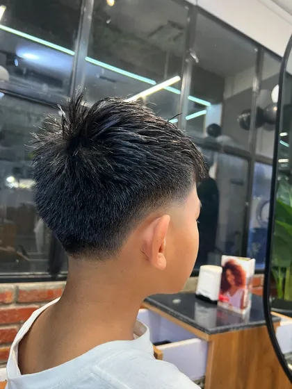 A clean and precise low taper fade. This is a versatile haircut that looks sharp and is easy to maintain.